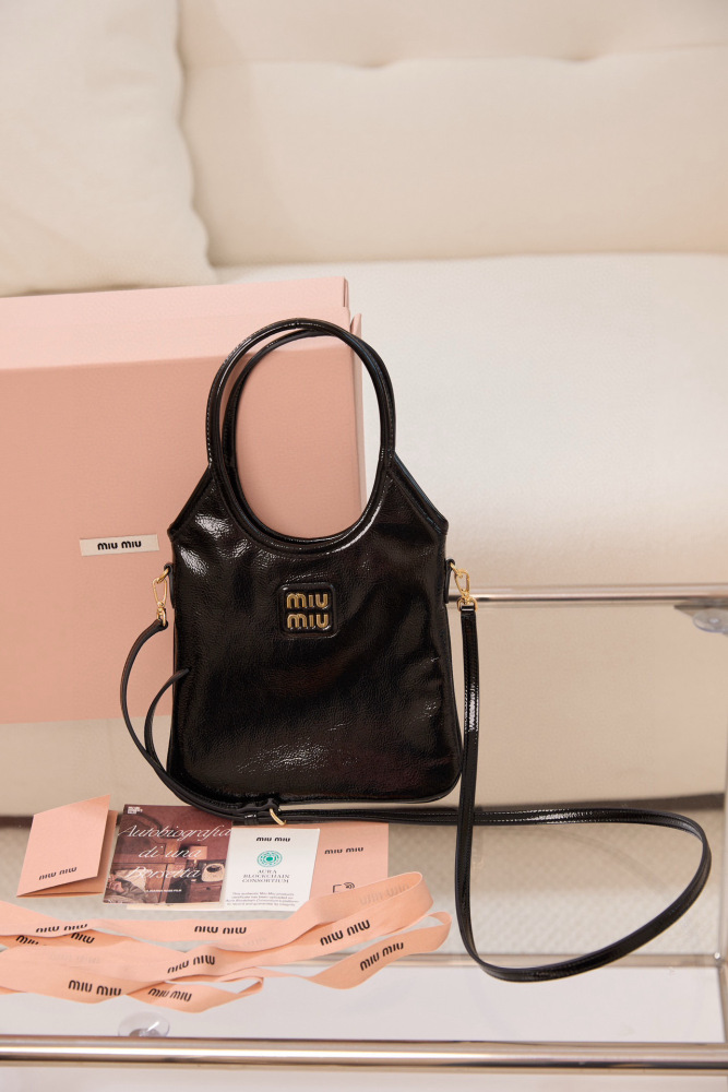 The Miu Miu Glossy Leather Handbag (Item No. 5BA327—often referred to as the "Small Hobo / Tote") is one of the brand's popular retro-style shoulder bags of recent years.