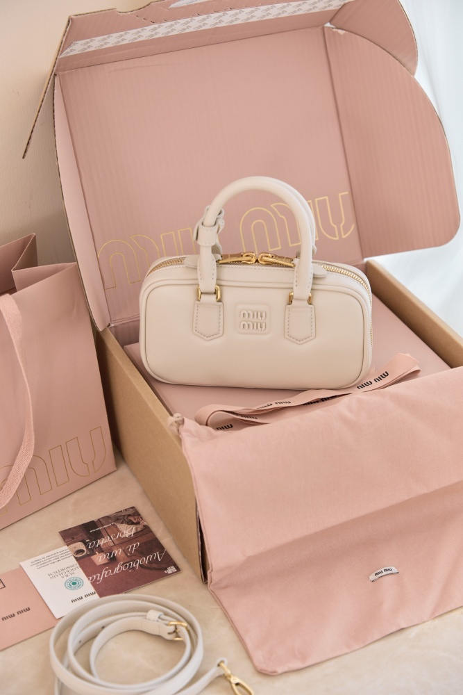 The Miu Miu Arcadie Small Leather Bowling Bag—often referred to as the "Mini Boston Bag" or "Pillow Bag"—is one of the brand's most popular styles in recent years, embodying a retro, sweet-girl aesthetic.