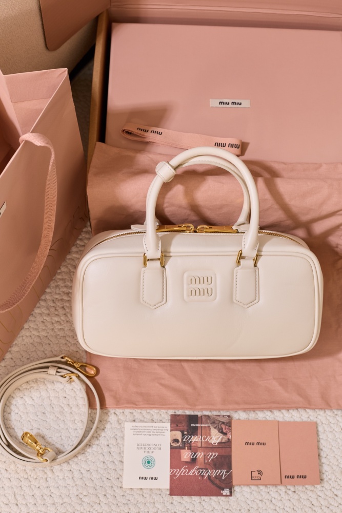 The Miu Miu Arcadie Medium Leather Bowling Bag (in White) is one of the brand's popular retro Y2K-style handbags.
