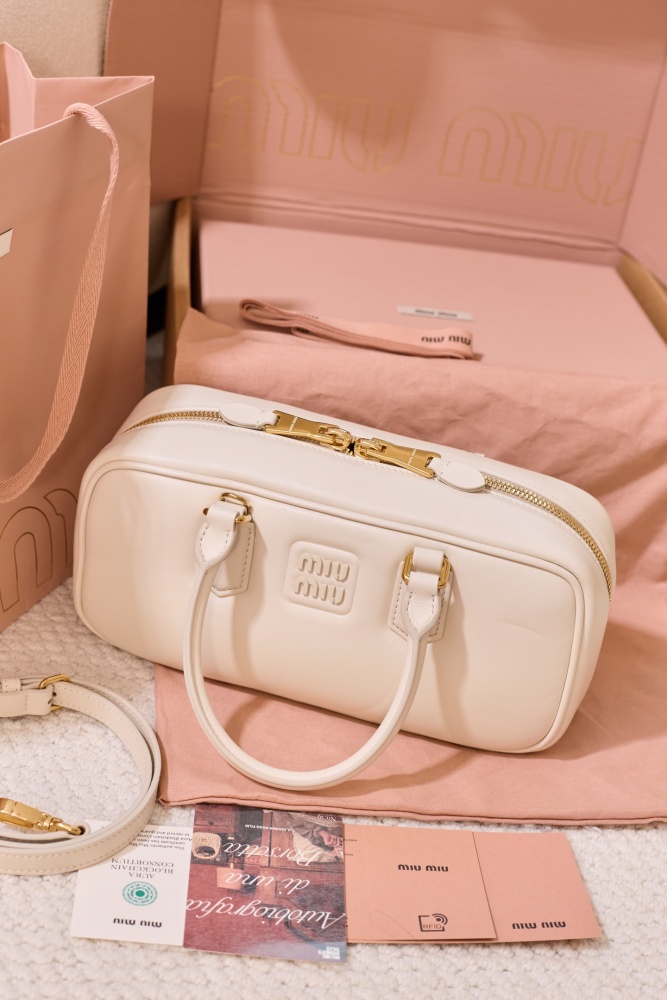 The Miu Miu Arcadie Medium Leather Bowling Bag (in White) is one of the brand's popular retro Y2K-style handbags.