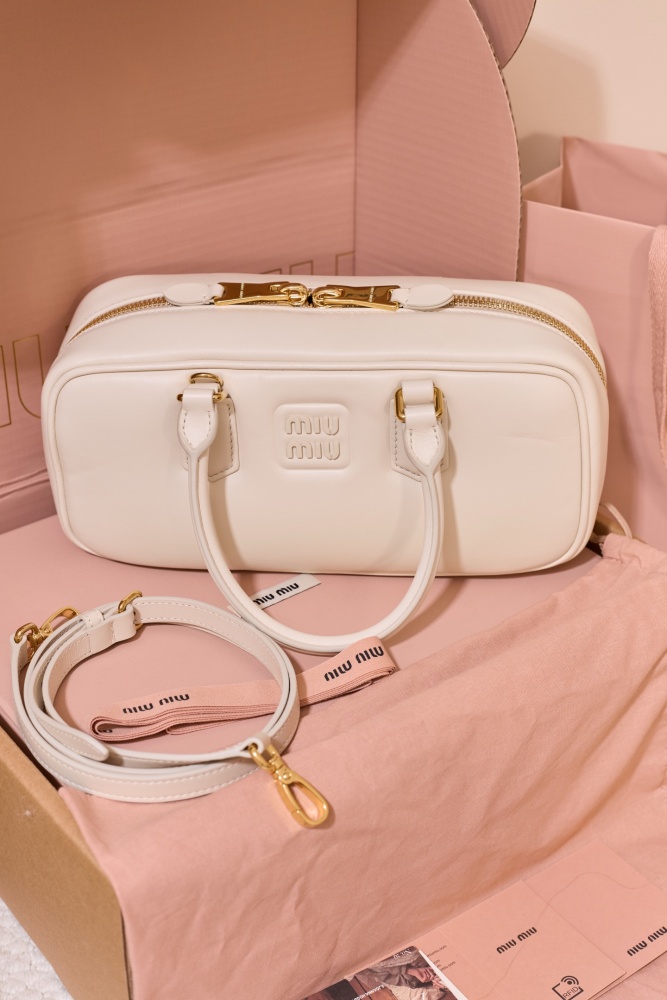 The Miu Miu Arcadie Medium Leather Bowling Bag (in White) is one of the brand's popular retro Y2K-style handbags.