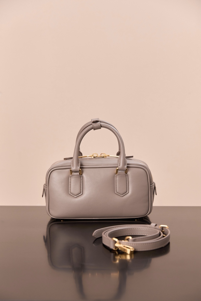 The Miu Miu Arcadie Small Leather Bowling Bag (Elephant Grey) is one of the brand's popular retro Y2K-style handbags.