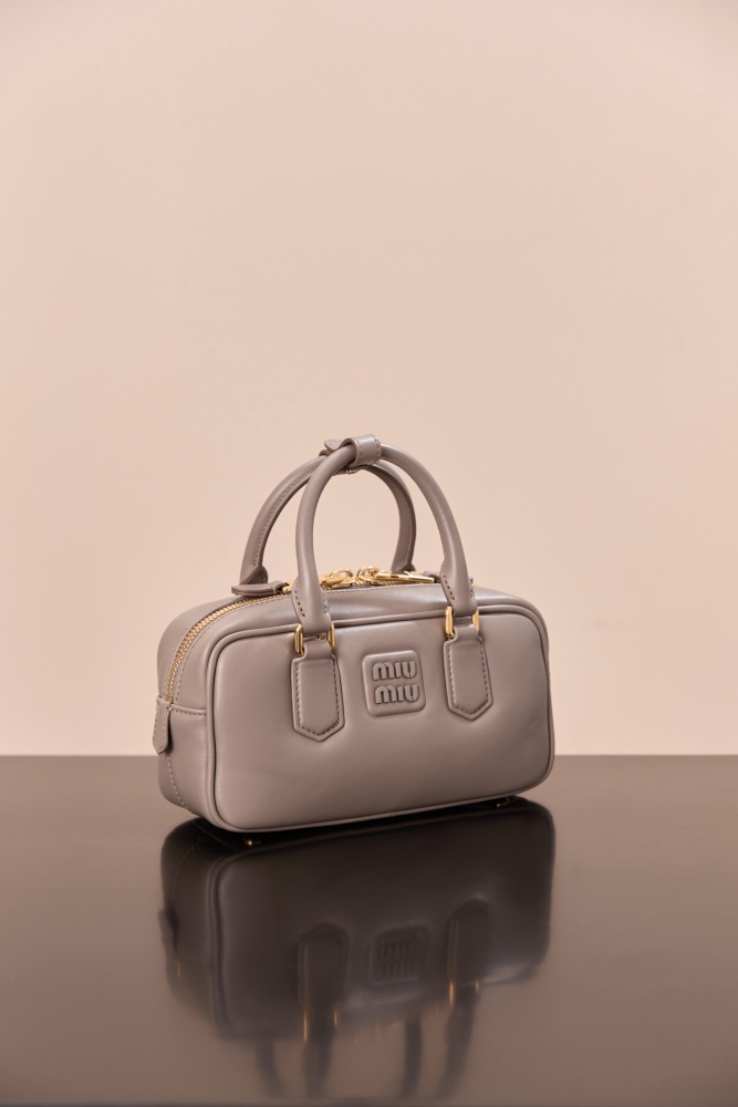 The Miu Miu Arcadie Small Leather Bowling Bag (Elephant Grey) is one of the brand's popular retro Y2K-style handbags.
