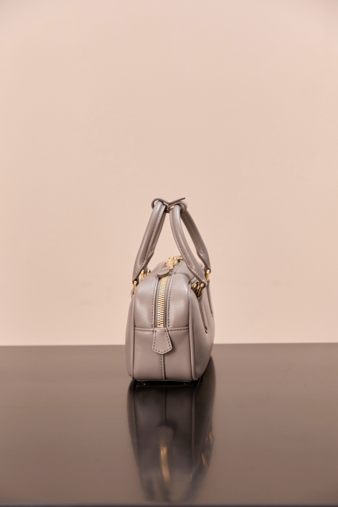 The Miu Miu Arcadie Small Leather Bowling Bag (Elephant Grey) is one of the brand's popular retro Y2K-style handbags.