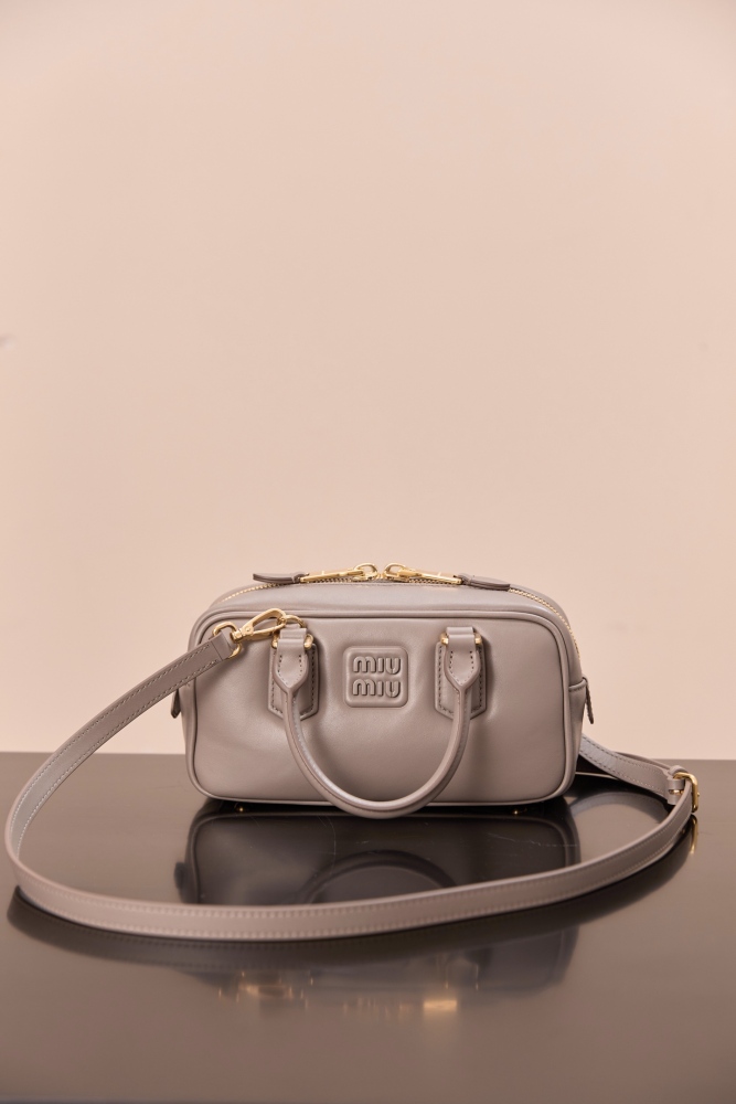 The Miu Miu Arcadie Small Leather Bowling Bag (Elephant Grey) is one of the brand's popular retro Y2K-style handbags.
