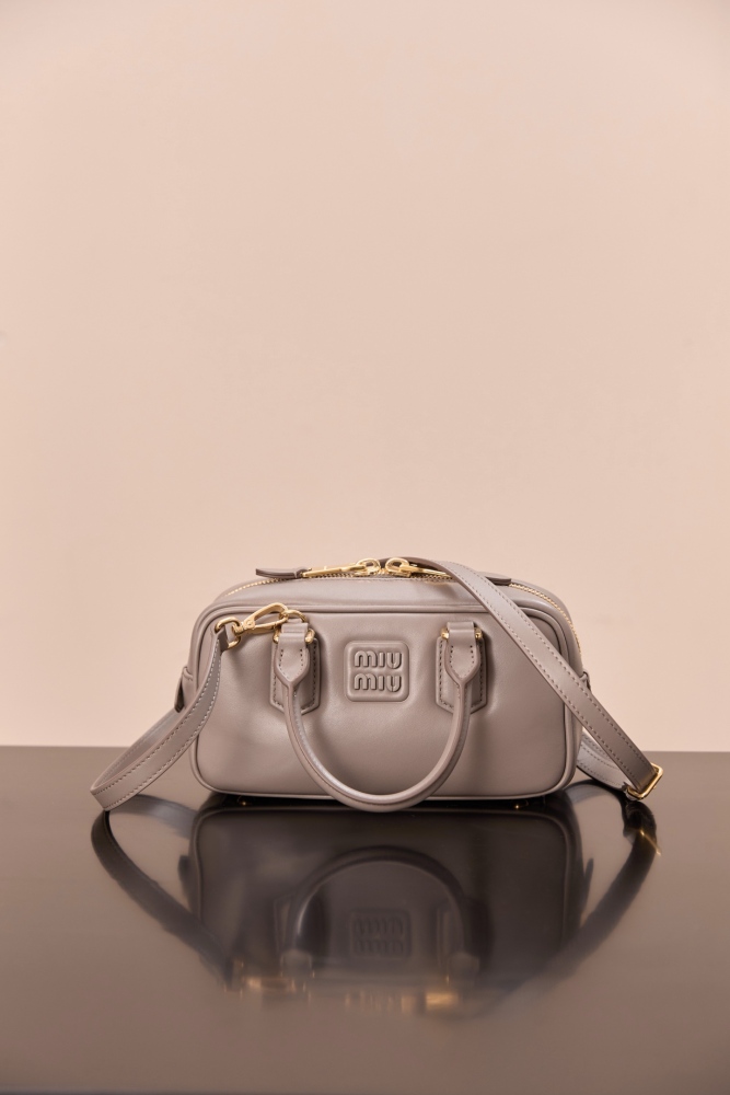 The Miu Miu Arcadie Small Leather Bowling Bag (Elephant Grey) is one of the brand's popular retro Y2K-style handbags.