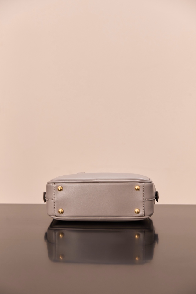 The Miu Miu Arcadie Small Leather Bowling Bag (Elephant Grey) is one of the brand's popular retro Y2K-style handbags.