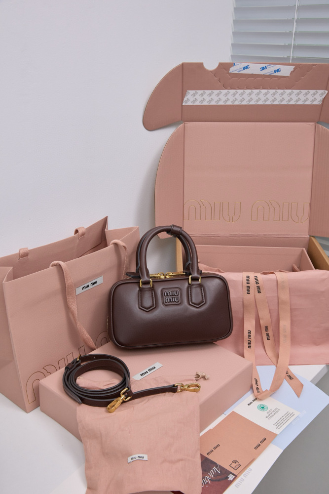 The Miu Miu Arcadie Small Leather Bowling Bag (in Chocolate Brown) is a highly sought-after handbag from the brand in recent years, embodying the popular retro Y2K aesthetic.