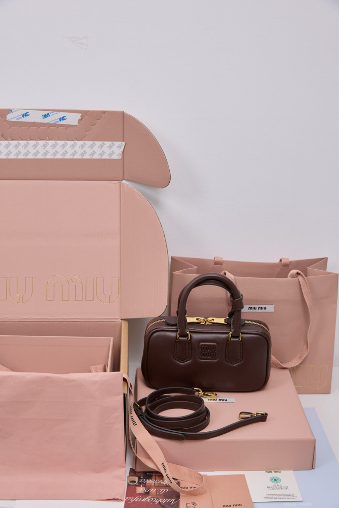 The Miu Miu Arcadie Small Leather Bowling Bag (in Chocolate Brown) is a highly sought-after handbag from the brand in recent years, embodying the popular retro Y2K aesthetic.