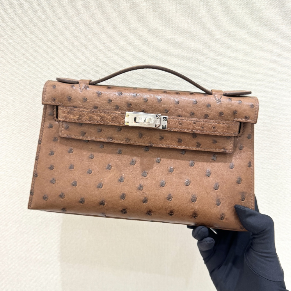 The Hermès Mini Kelly I (also known as the Kelly Pochette) Ostrich Leather Handbag is one of the brand's classic exotic leather models.