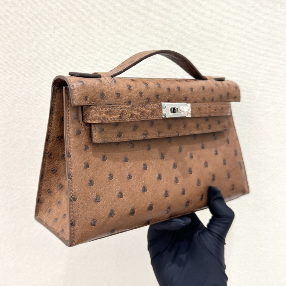 The Hermès Mini Kelly I (also known as the Kelly Pochette) Ostrich Leather Handbag is one of the brand's classic exotic leather models.