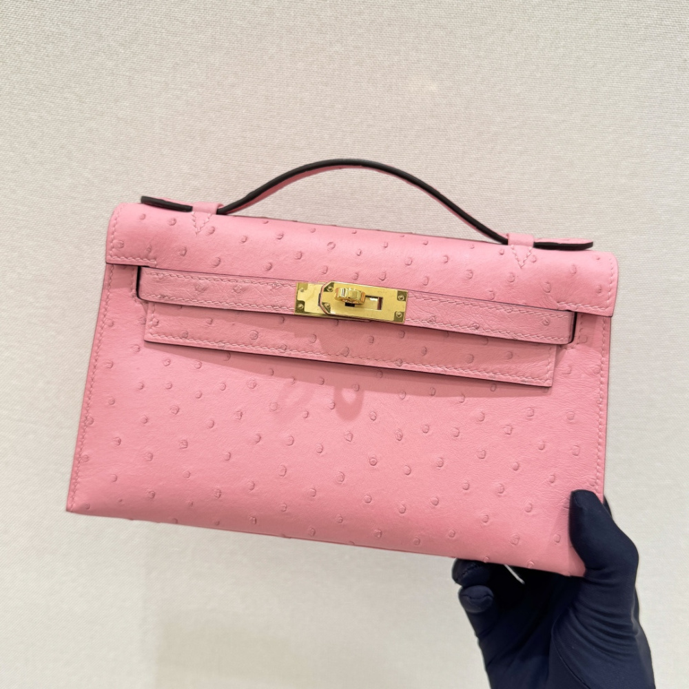 The Hermès Mini Kelly I (also known as the Kelly Pochette) Ostrich Leather Handbag is one of the brand's classic exotic leather models.