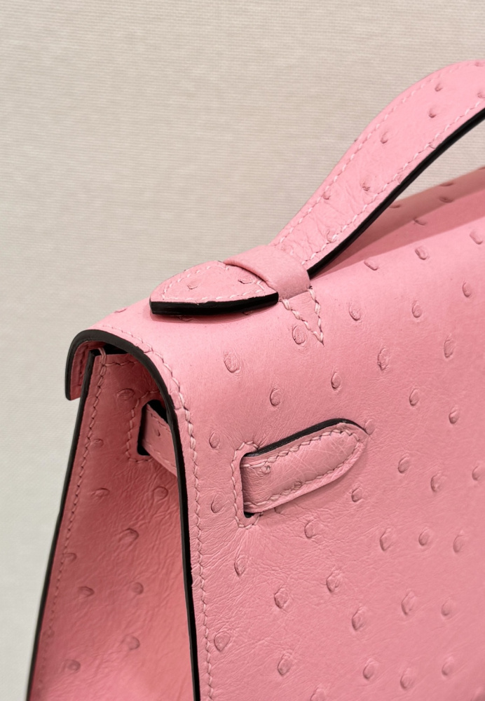 The Hermès Mini Kelly I (also known as the Kelly Pochette) Ostrich Leather Handbag is one of the brand's classic exotic leather models.