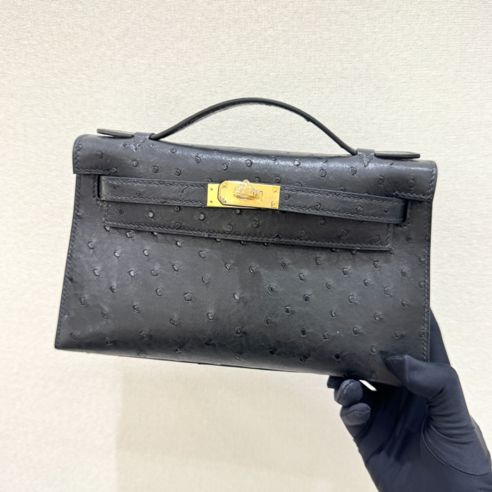 The Hermès Mini Kelly I (also known as the Kelly Pochette) Ostrich Leather Handbag is one of the brand's classic exotic leather models.