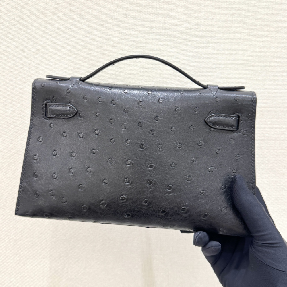 The Hermès Mini Kelly I (also known as the Kelly Pochette) Ostrich Leather Handbag is one of the brand's classic exotic leather models.