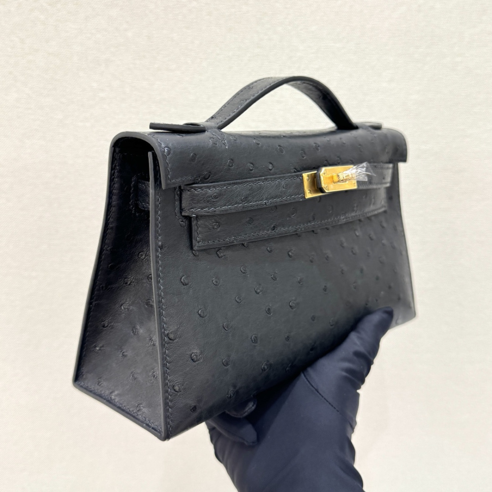 The Hermès Mini Kelly I (also known as the Kelly Pochette) Ostrich Leather Handbag is one of the brand's classic exotic leather models.