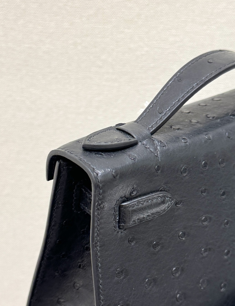 The Hermès Mini Kelly I (also known as the Kelly Pochette) Ostrich Leather Handbag is one of the brand's classic exotic leather models.