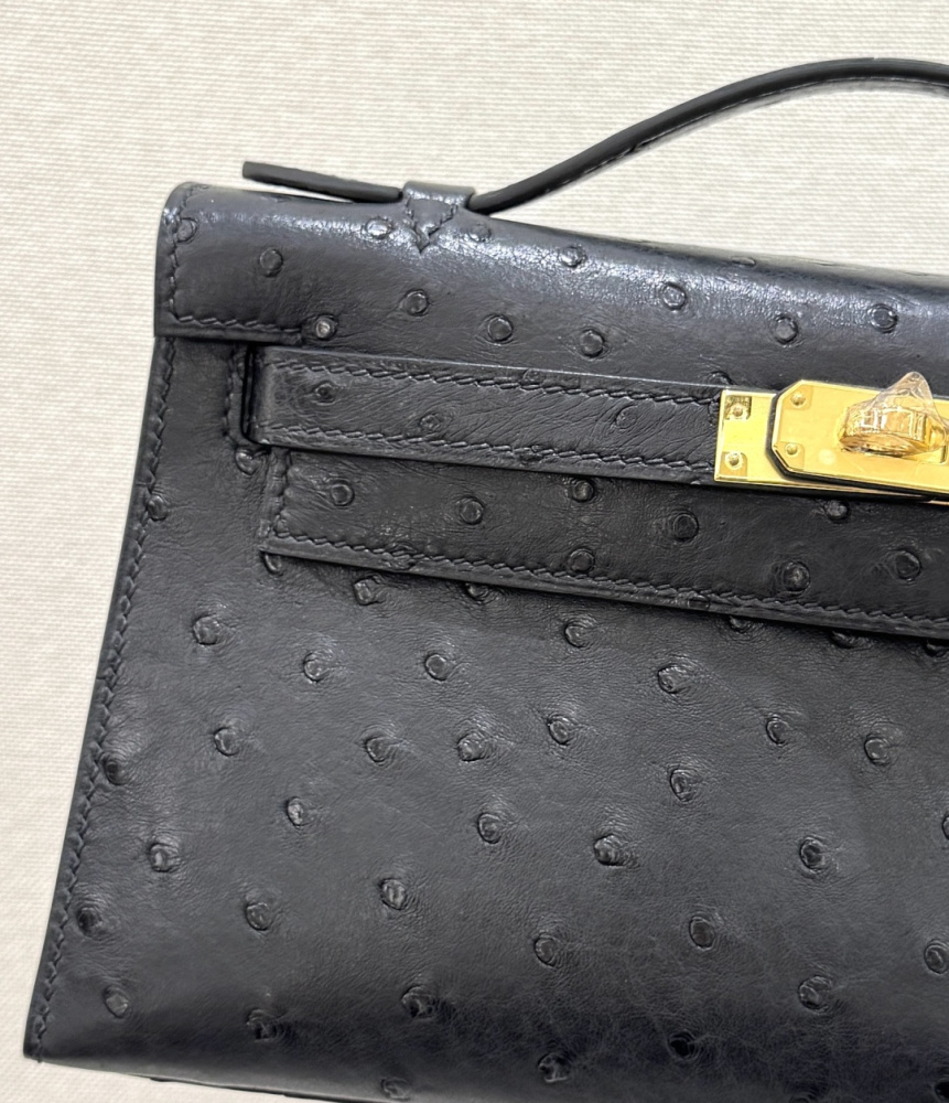 The Hermès Mini Kelly I (also known as the Kelly Pochette) Ostrich Leather Handbag is one of the brand's classic exotic leather models.