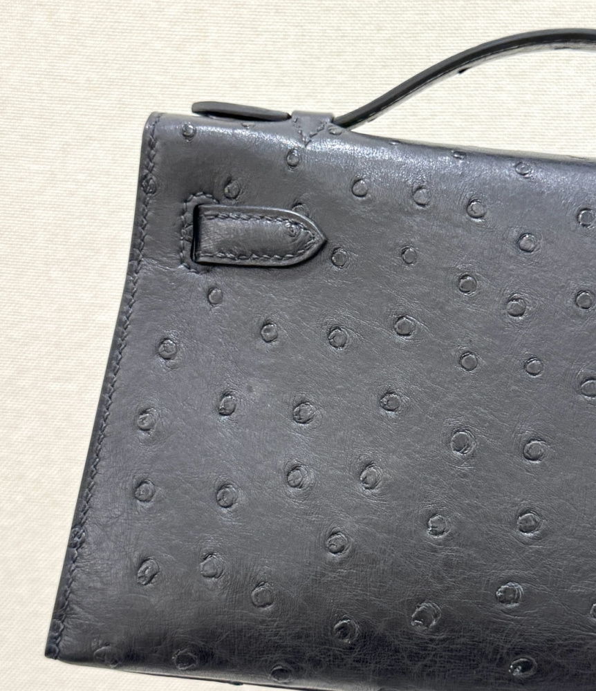 The Hermès Mini Kelly I (also known as the Kelly Pochette) Ostrich Leather Handbag is one of the brand's classic exotic leather models.