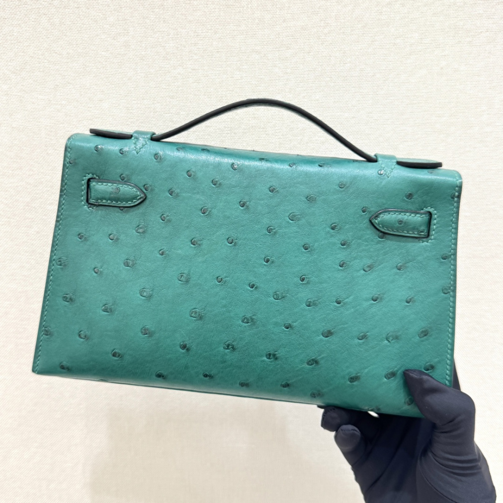 The Hermès Mini Kelly I (also known as the Kelly Pochette) Ostrich Leather Handbag is one of the brand's classic exotic leather models.