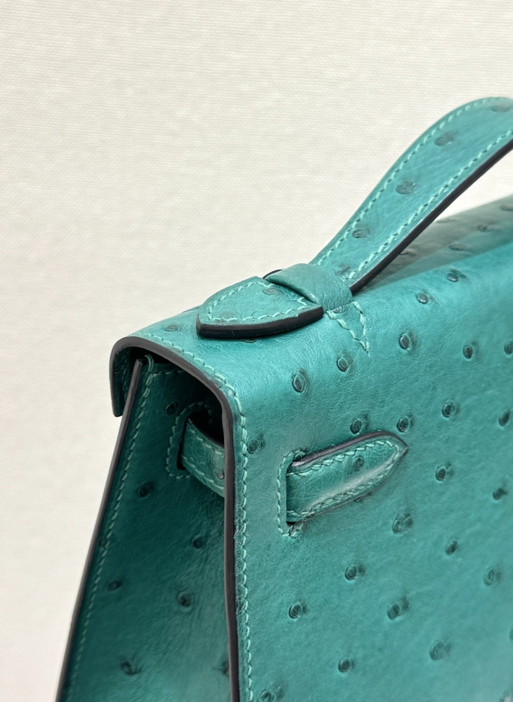 The Hermès Mini Kelly I (also known as the Kelly Pochette) Ostrich Leather Handbag is one of the brand's classic exotic leather models.