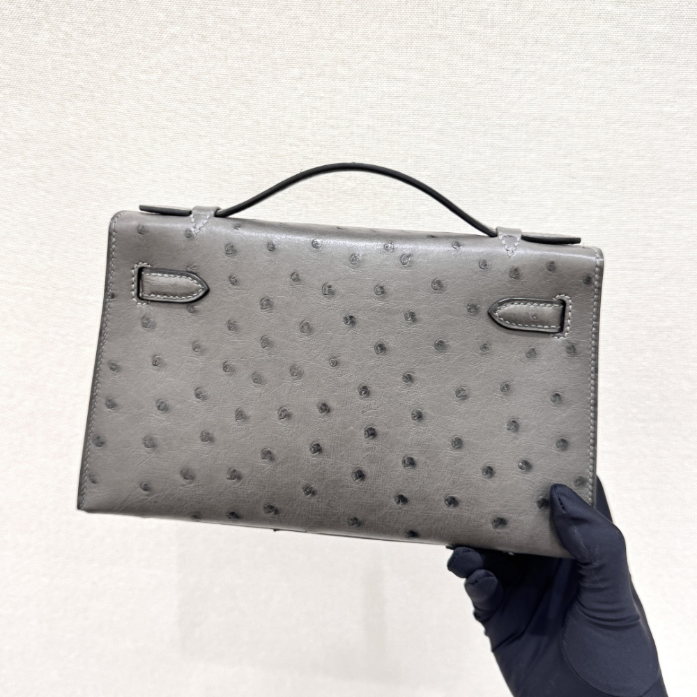The Hermès Mini Kelly I (also known as the Kelly Pochette) Ostrich Leather Handbag is one of the brand's classic exotic leather models.