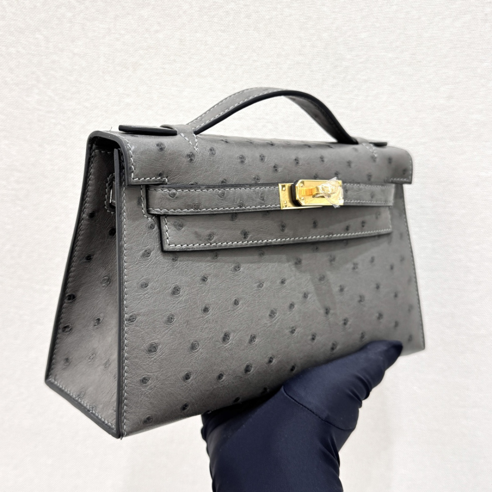 The Hermès Mini Kelly I (also known as the Kelly Pochette) Ostrich Leather Handbag is one of the brand's classic exotic leather models.