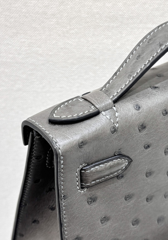 The Hermès Mini Kelly I (also known as the Kelly Pochette) Ostrich Leather Handbag is one of the brand's classic exotic leather models.