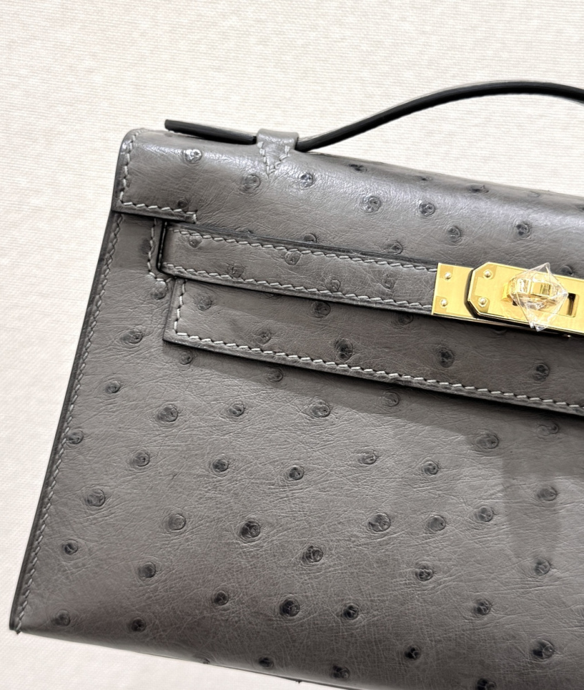 The Hermès Mini Kelly I (also known as the Kelly Pochette) Ostrich Leather Handbag is one of the brand's classic exotic leather models.