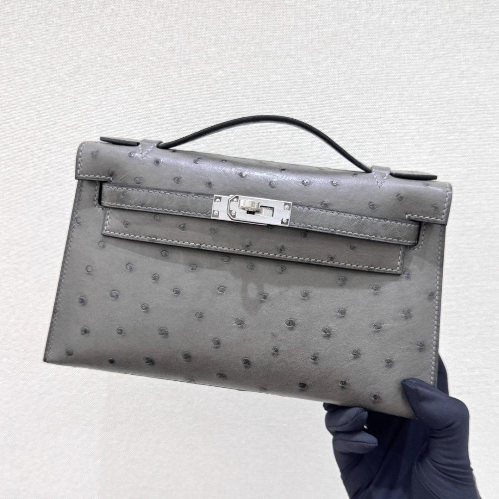The Hermès Mini Kelly I (also known as the Kelly Pochette) Ostrich Leather Handbag is one of the brand's classic exotic leather models.