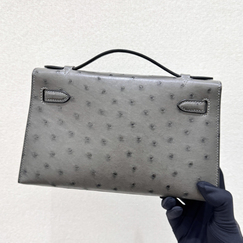 The Hermès Mini Kelly I (also known as the Kelly Pochette) Ostrich Leather Handbag is one of the brand's classic exotic leather models.