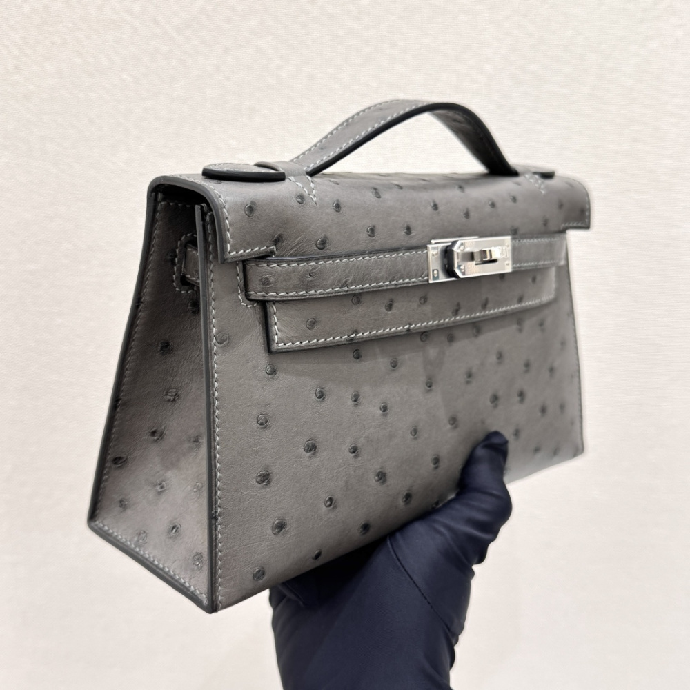 The Hermès Mini Kelly I (also known as the Kelly Pochette) Ostrich Leather Handbag is one of the brand's classic exotic leather models.