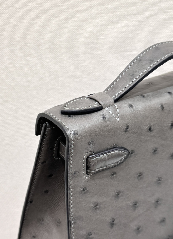 The Hermès Mini Kelly I (also known as the Kelly Pochette) Ostrich Leather Handbag is one of the brand's classic exotic leather models.