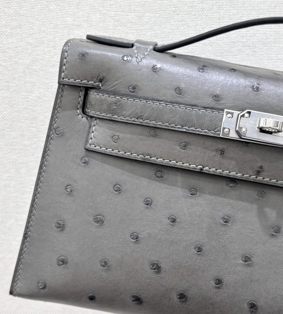 The Hermès Mini Kelly I (also known as the Kelly Pochette) Ostrich Leather Handbag is one of the brand's classic exotic leather models.