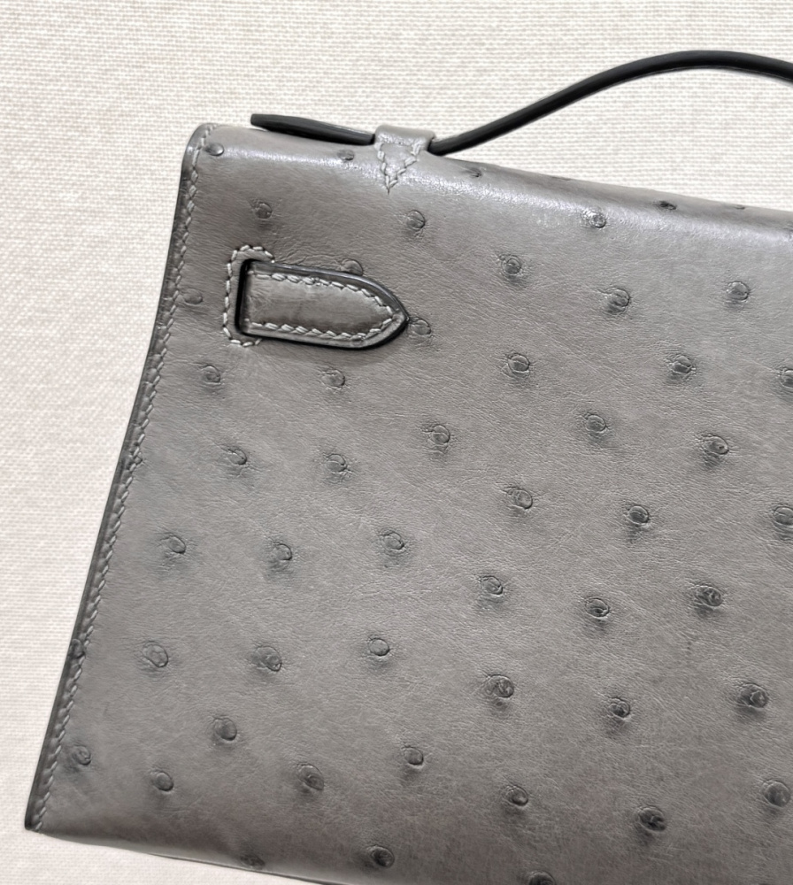 The Hermès Mini Kelly I (also known as the Kelly Pochette) Ostrich Leather Handbag is one of the brand's classic exotic leather models.