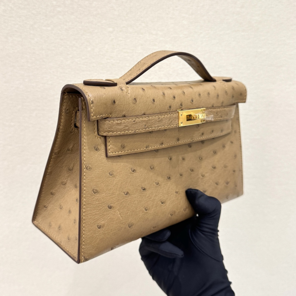 The Hermès Mini Kelly I (also known as the Kelly Pochette) Ostrich Leather Handbag is one of the brand's classic exotic leather models.