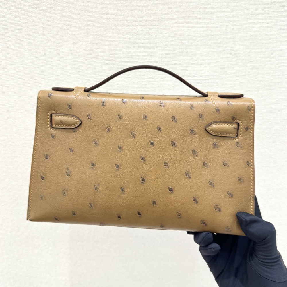 The Hermès Mini Kelly I (also known as the Kelly Pochette) Ostrich Leather Handbag is one of the brand's classic exotic leather models.