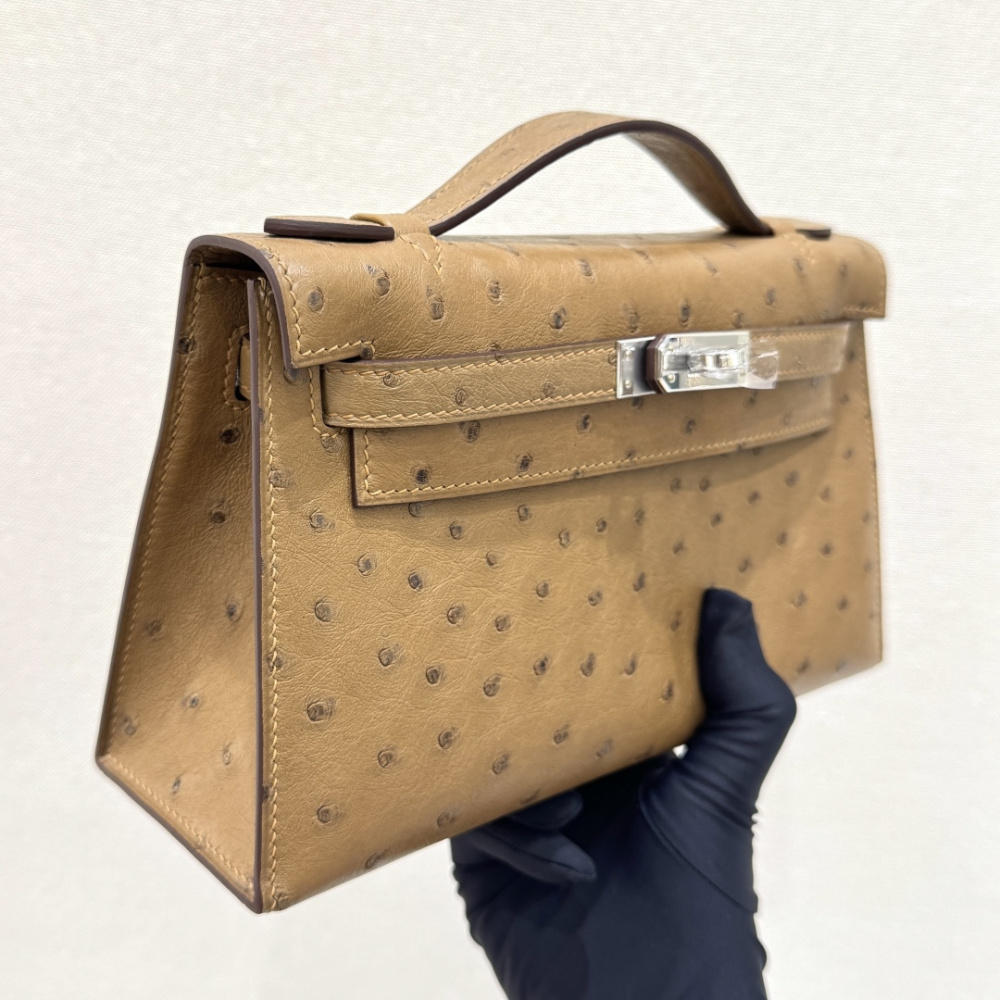 The Hermès Mini Kelly I (also known as the Kelly Pochette) Ostrich Leather Handbag is one of the brand's classic exotic leather models.