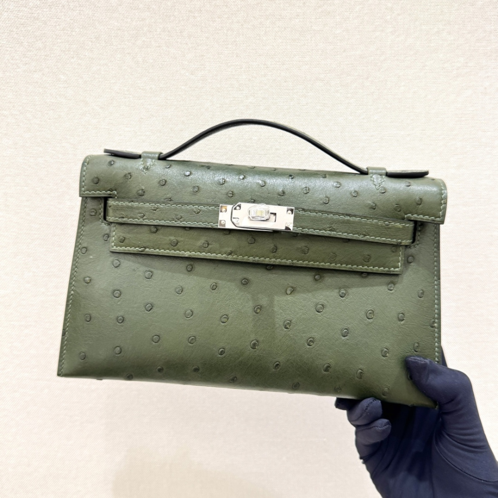 The Hermès Mini Kelly I (also known as the Kelly Pochette) Ostrich Leather Handbag is one of the brand's classic exotic leather models.