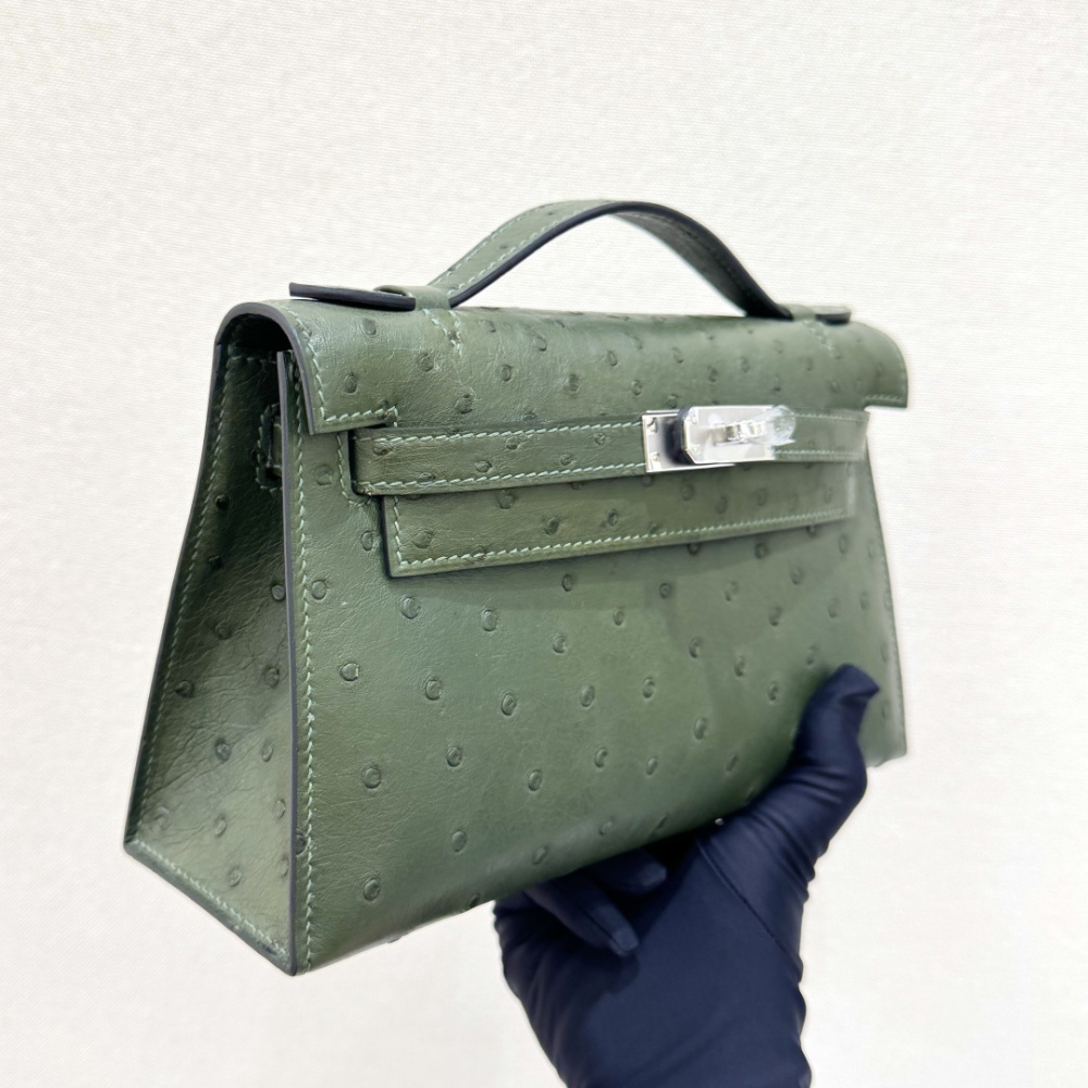 The Hermès Mini Kelly I (also known as the Kelly Pochette) Ostrich Leather Handbag is one of the brand's classic exotic leather models.