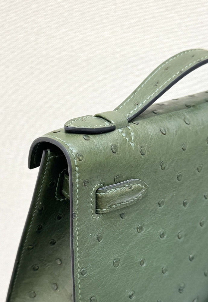 The Hermès Mini Kelly I (also known as the Kelly Pochette) Ostrich Leather Handbag is one of the brand's classic exotic leather models.