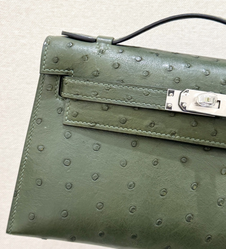 The Hermès Mini Kelly I (also known as the Kelly Pochette) Ostrich Leather Handbag is one of the brand's classic exotic leather models.