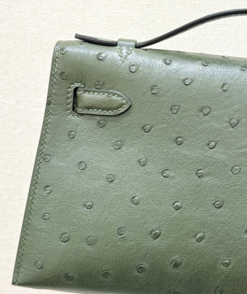 The Hermès Mini Kelly I (also known as the Kelly Pochette) Ostrich Leather Handbag is one of the brand's classic exotic leather models.