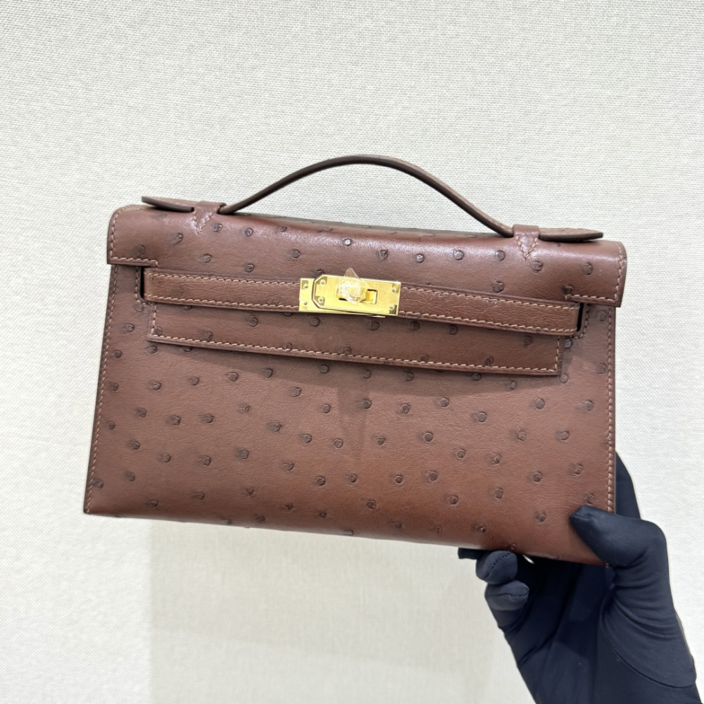 The Hermès Mini Kelly I (also known as the Kelly Pochette) Ostrich Leather Handbag is one of the brand's classic exotic leather models.