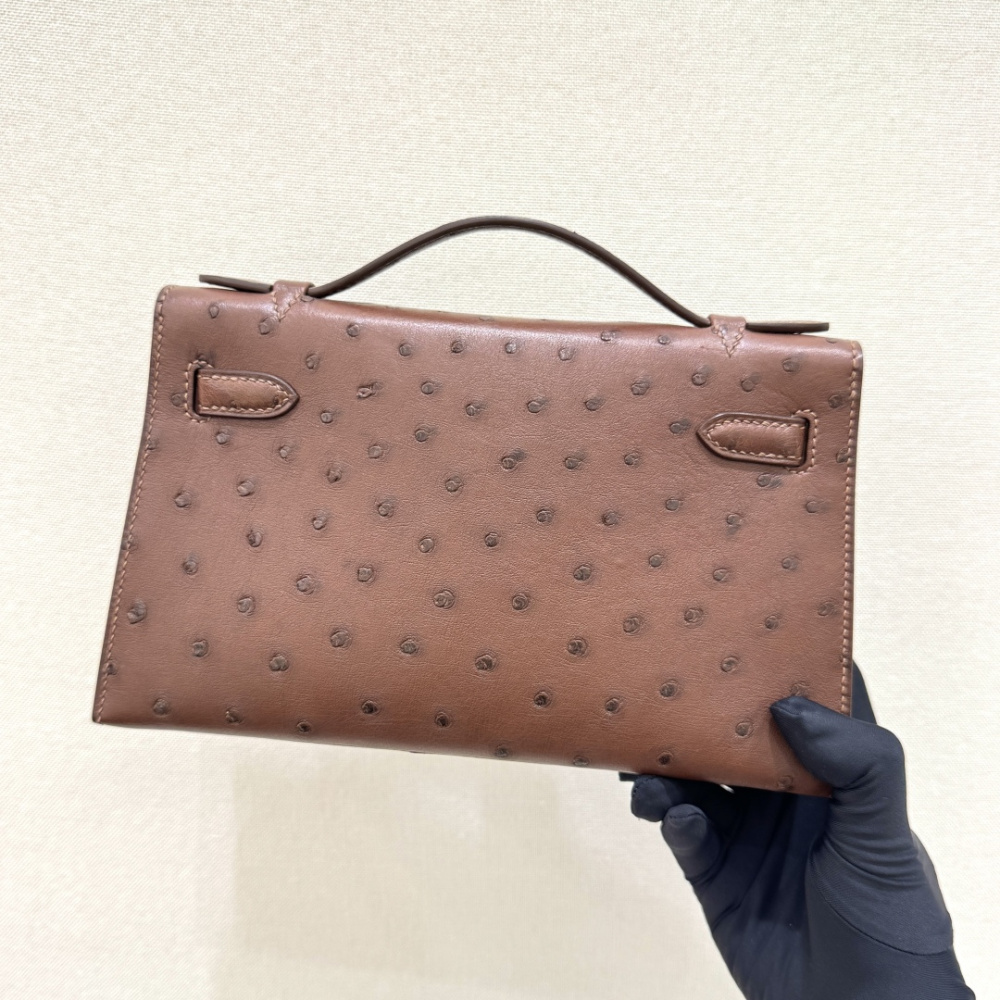 The Hermès Mini Kelly I (also known as the Kelly Pochette) Ostrich Leather Handbag is one of the brand's classic exotic leather models.