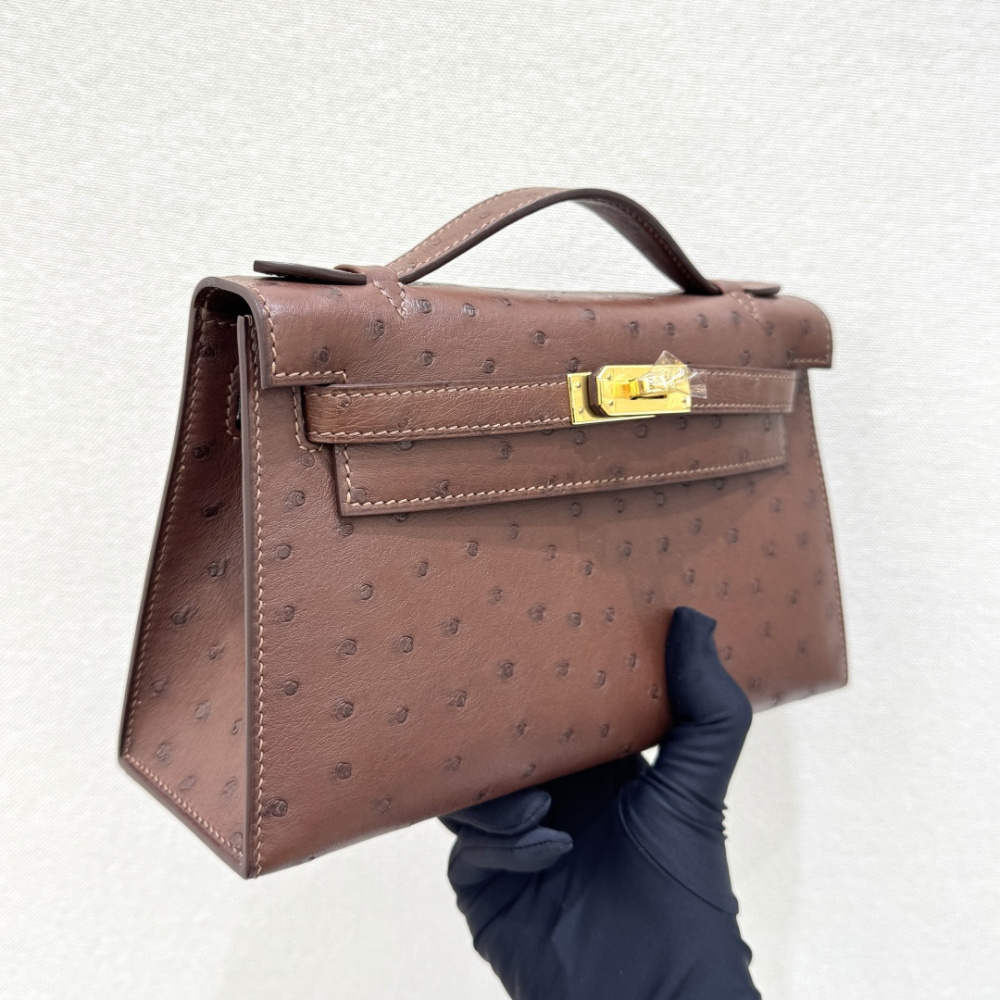 The Hermès Mini Kelly I (also known as the Kelly Pochette) Ostrich Leather Handbag is one of the brand's classic exotic leather models.