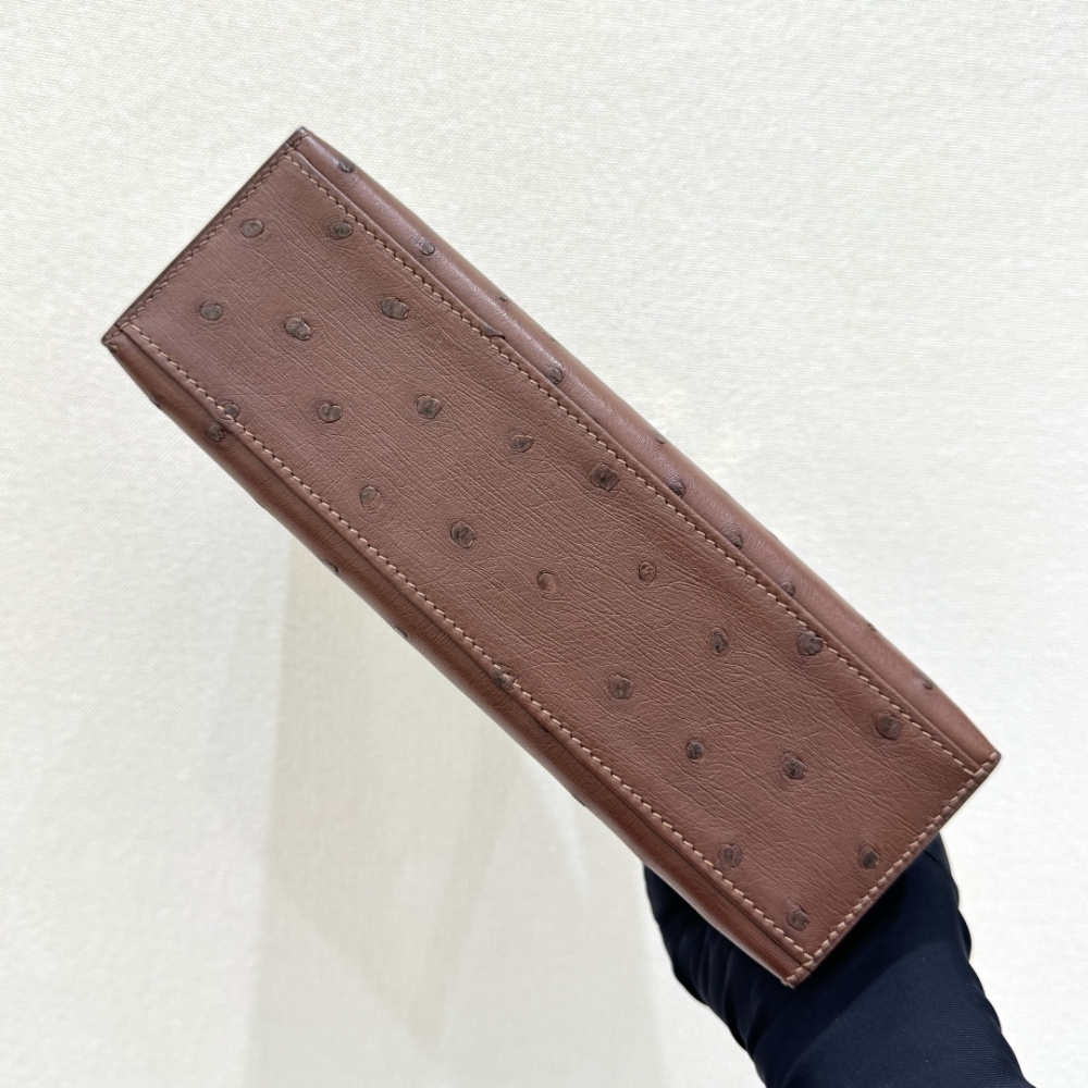 The Hermès Mini Kelly I (also known as the Kelly Pochette) Ostrich Leather Handbag is one of the brand's classic exotic leather models.