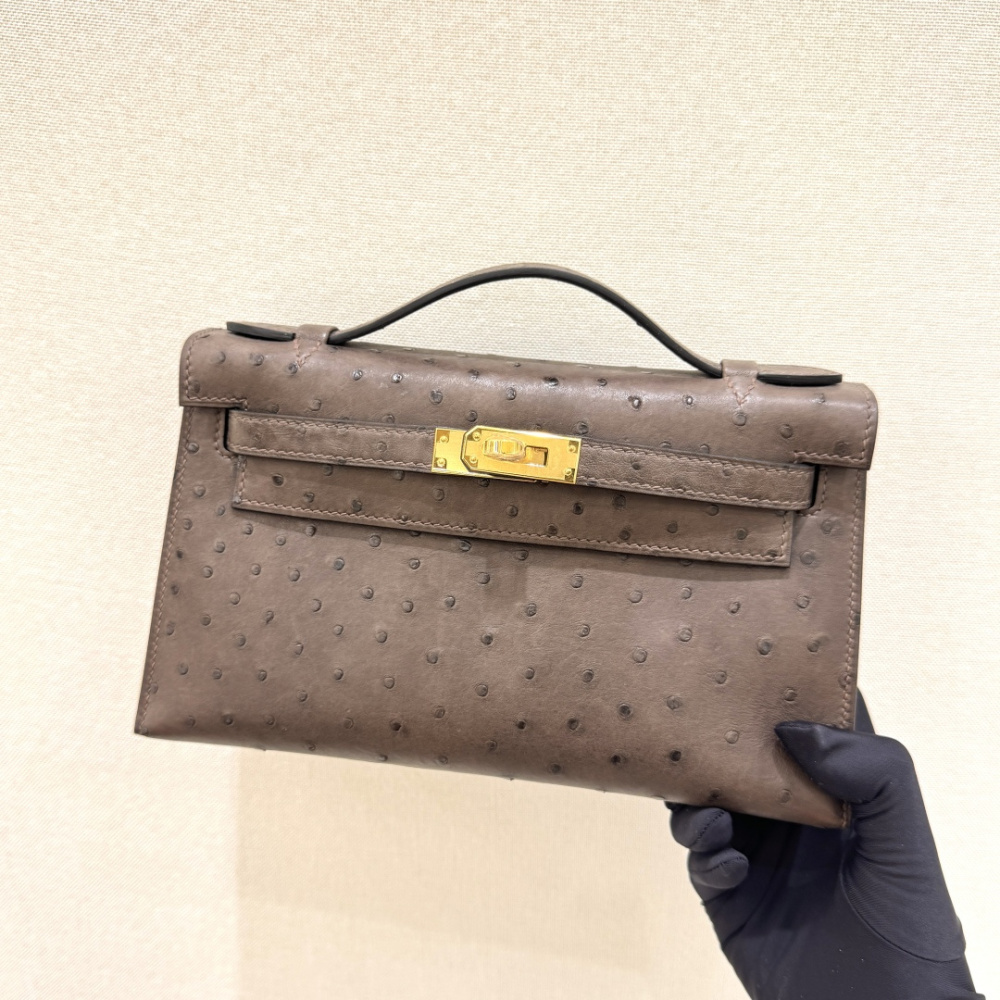 The Hermès Mini Kelly I (also known as the Kelly Pochette) Ostrich Leather Handbag is one of the brand's classic exotic leather models.