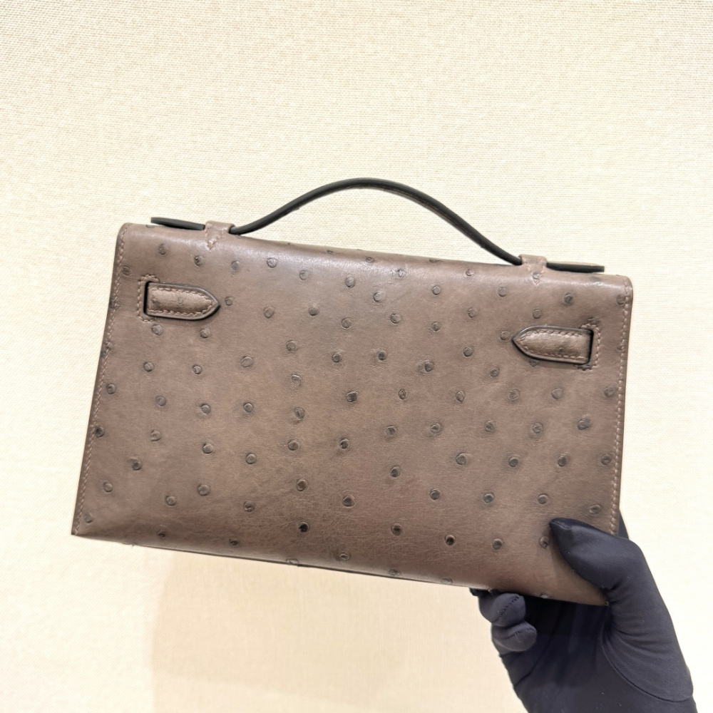 The Hermès Mini Kelly I (also known as the Kelly Pochette) Ostrich Leather Handbag is one of the brand's classic exotic leather models.