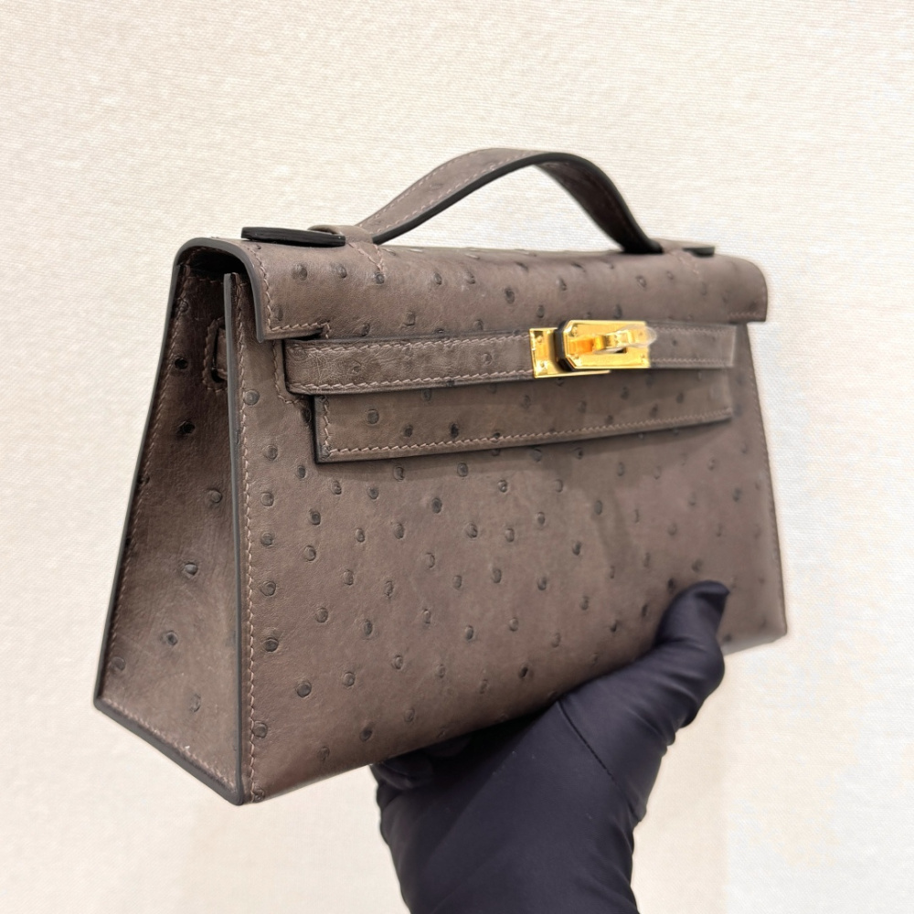 The Hermès Mini Kelly I (also known as the Kelly Pochette) Ostrich Leather Handbag is one of the brand's classic exotic leather models.